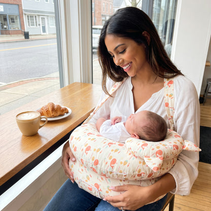 Oinkie nursing pillow worn by a mom with her baby